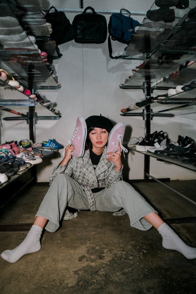 Eccentric woman with shoes in wardrobe